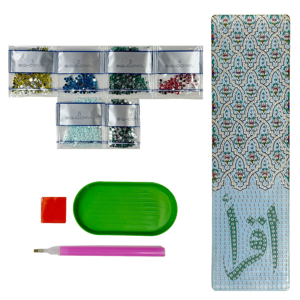 A DIY diamond painting craft kit laid out, including an acrylic Iqra bookmark, diamond gems, an applicator pen, a tray, and wax, ready for crafting.