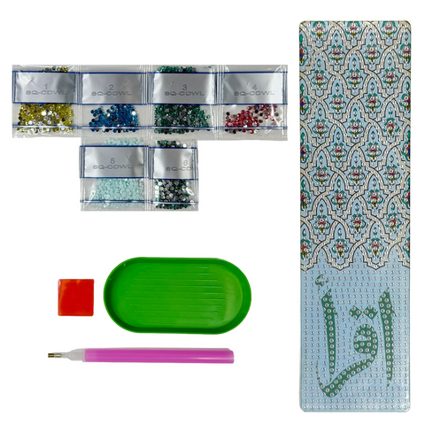 A DIY diamond painting craft kit laid out, including an acrylic Iqra bookmark, diamond gems, an applicator pen, a tray, and wax, ready for crafting.